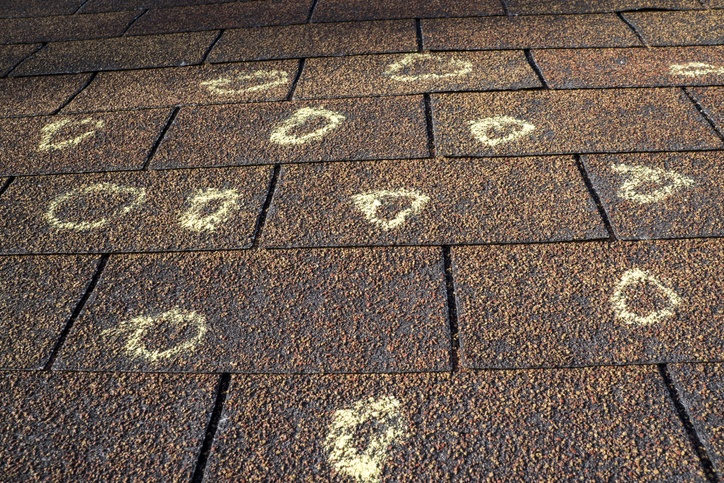 Grey Roof Shingles Marked with Hail Damage in Chalk After Roof Inspection Services