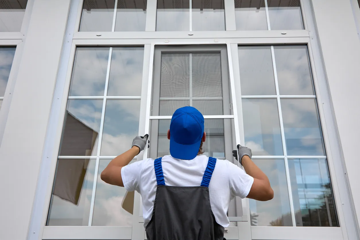 A general contractor repairs and installs a new window at a home in Colorado Springs